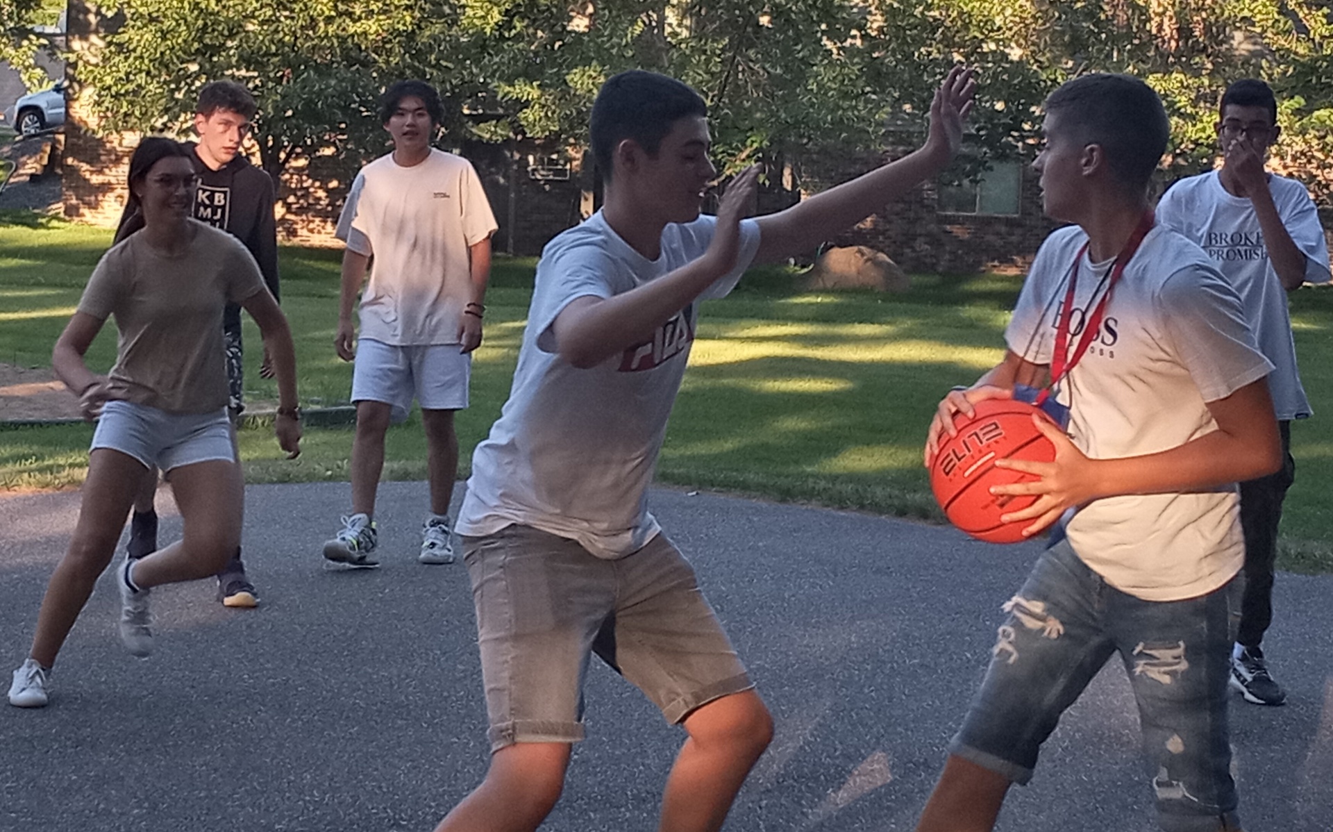 Youth Exchange students enjoying a pickup basketball game, July 2022.